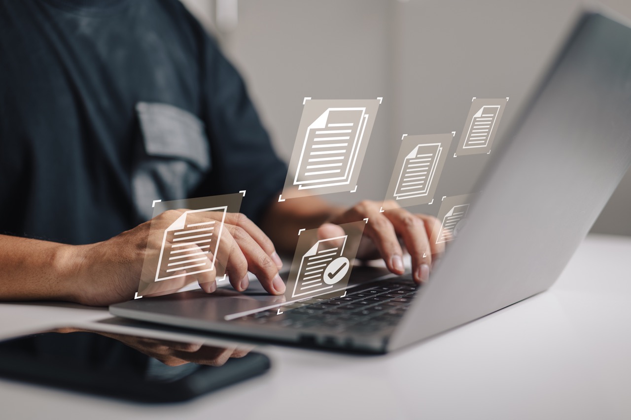 document management data system business internet technology concept of a businessman hand using a laptop computer with a document management icon.